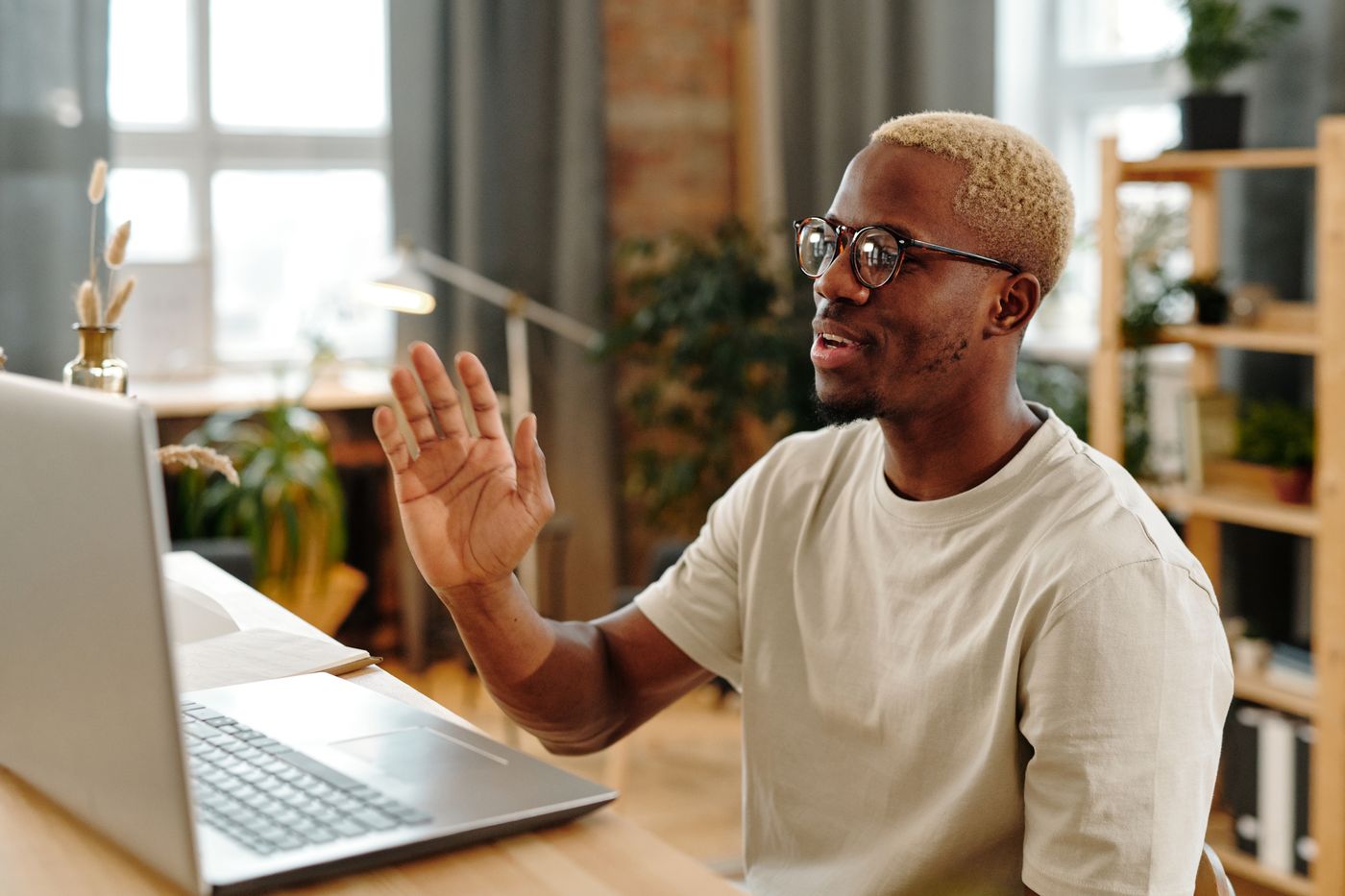 A man talking with a clinician during an online consultation from home